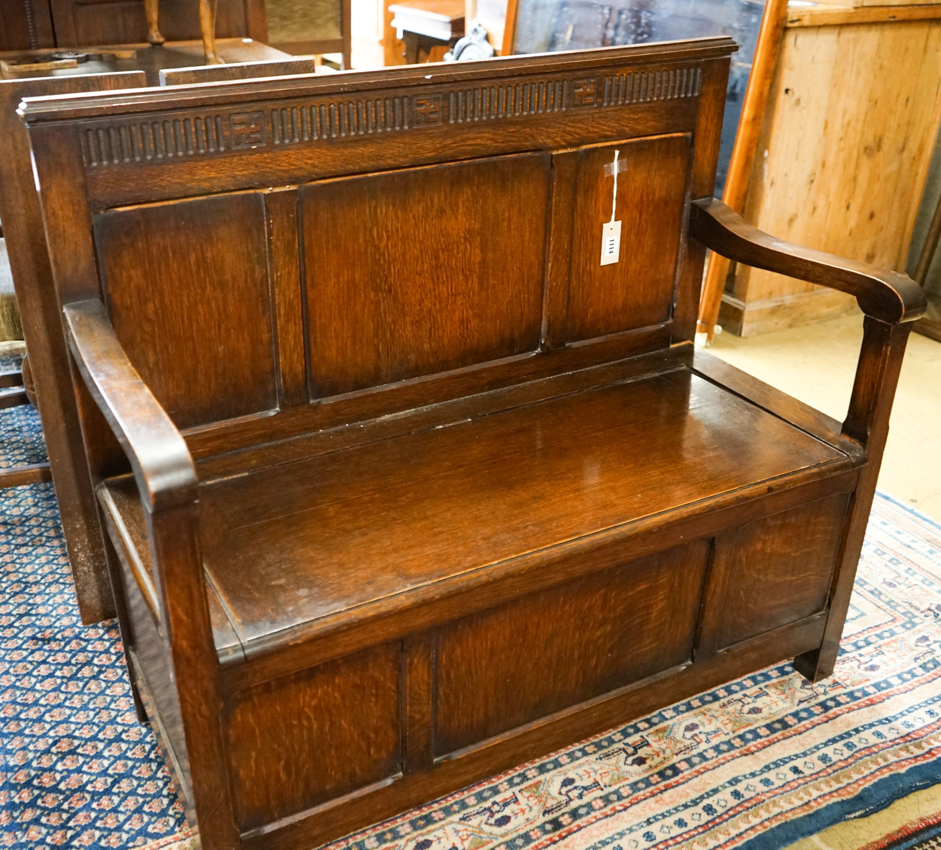A 1920's rectangular bevelled wall mirror in oak frame, width 53cm, height 74cm together with a late Victorian wall-mounted medicine cabinet and an 18th century style panelled oak box seat settle, width 108cm, depth 45cm